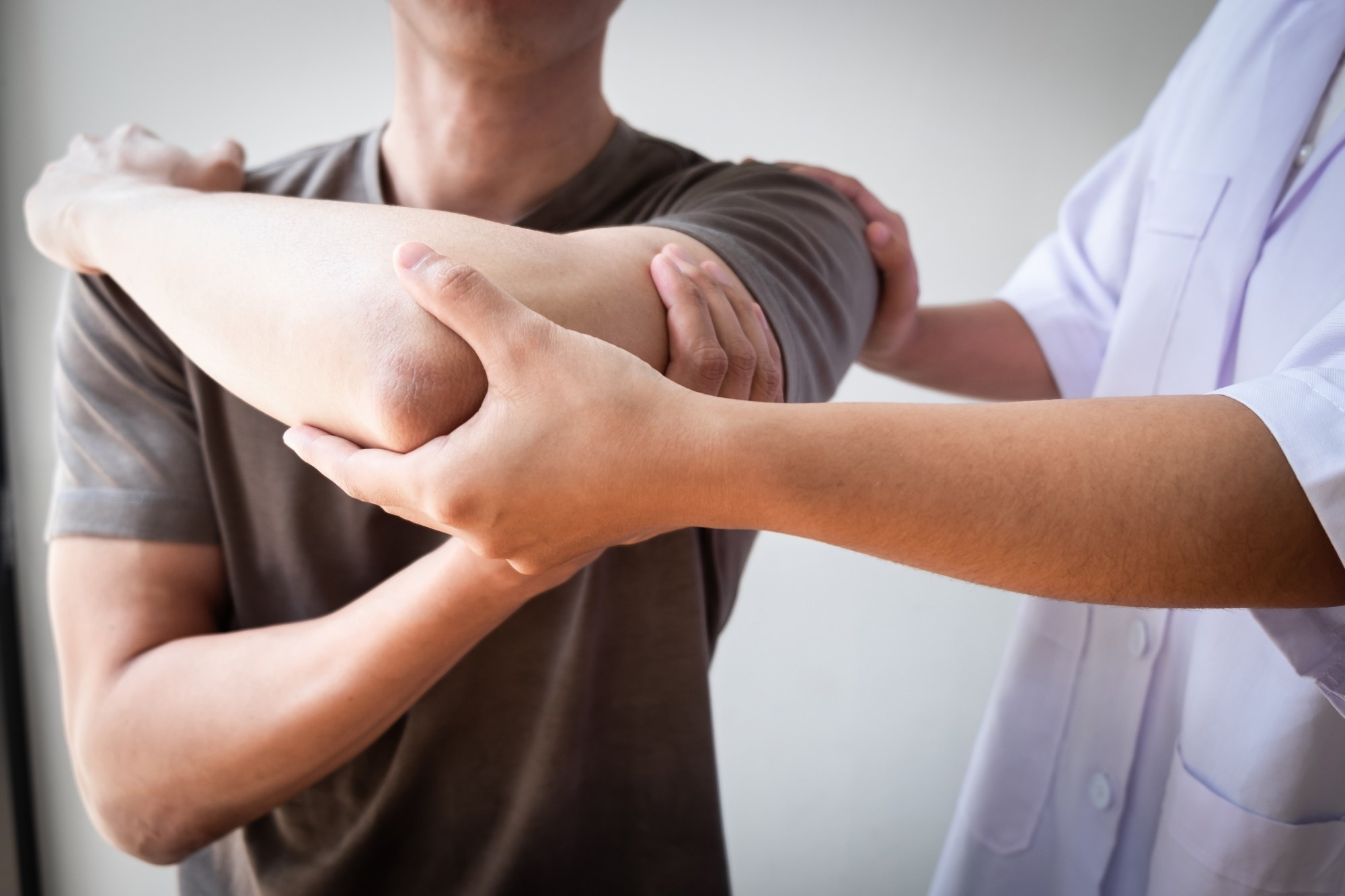 Physiotherapist helps man with rotator cuff injury