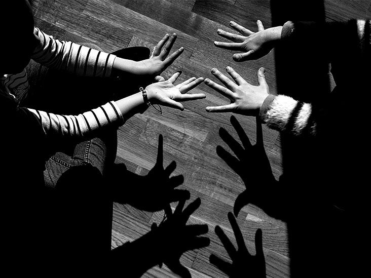 Shadows created by the hands of two young girls