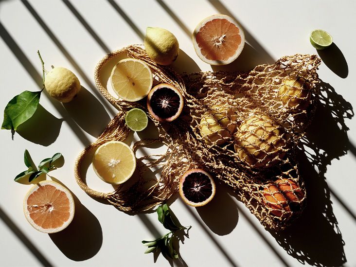 Overhead view of sliced citrus on a white table