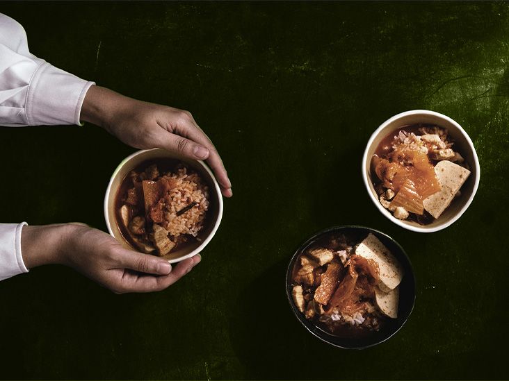Three bowls of kimchi on a table