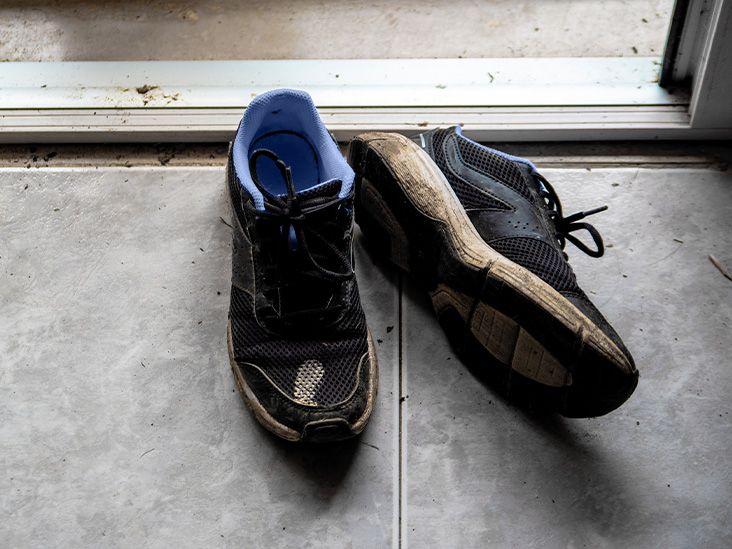 Muddy running shoes on a doorstep