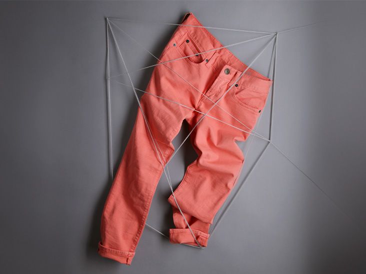 Rust colored jeans hanging on a string