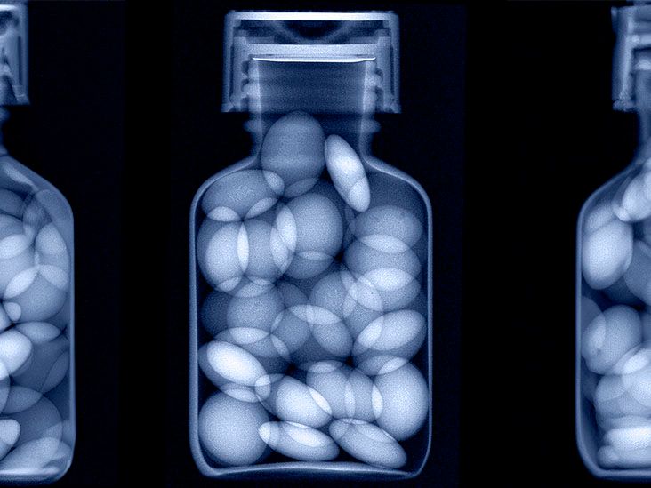 A blue-tinted x-ray of pills in a bottle