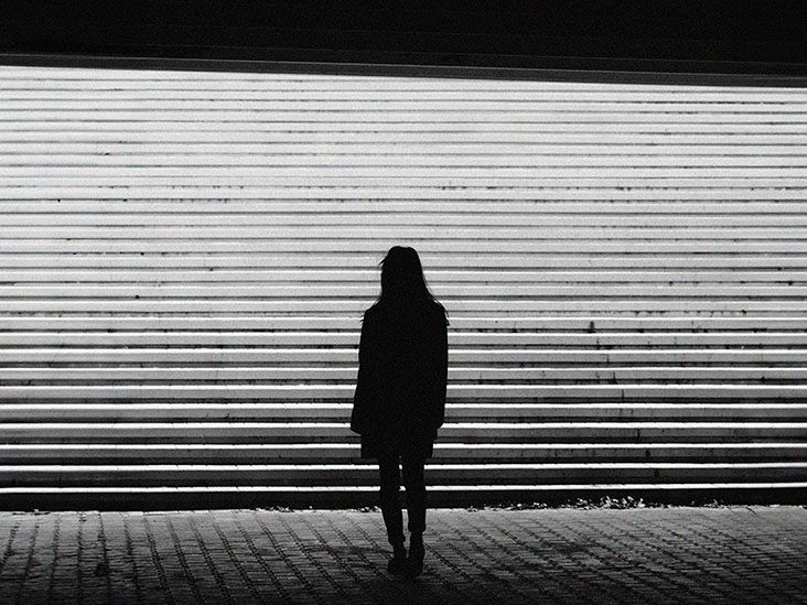 The silhouette of a woman near some concrete steps