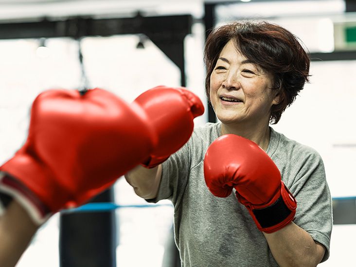 Older female boxing in a gym