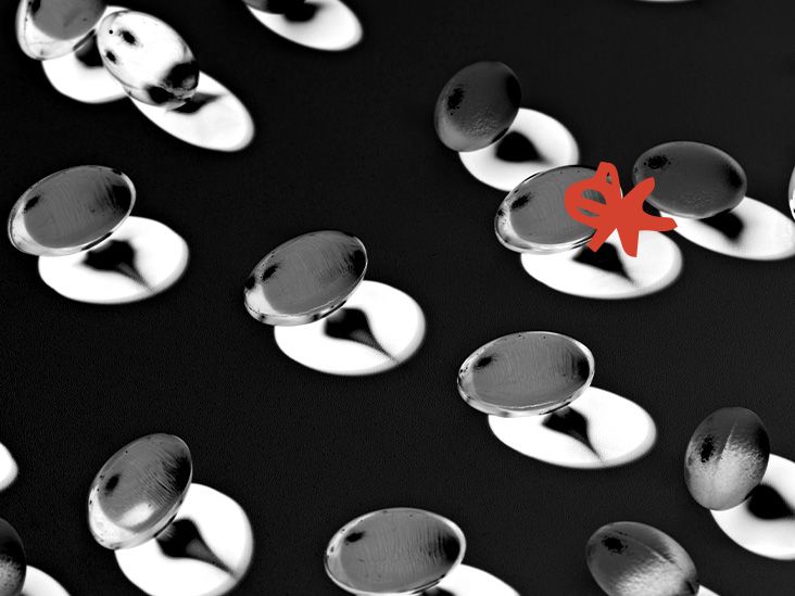 Omega-3 fish oil capsules and their shadows reflected on a surface