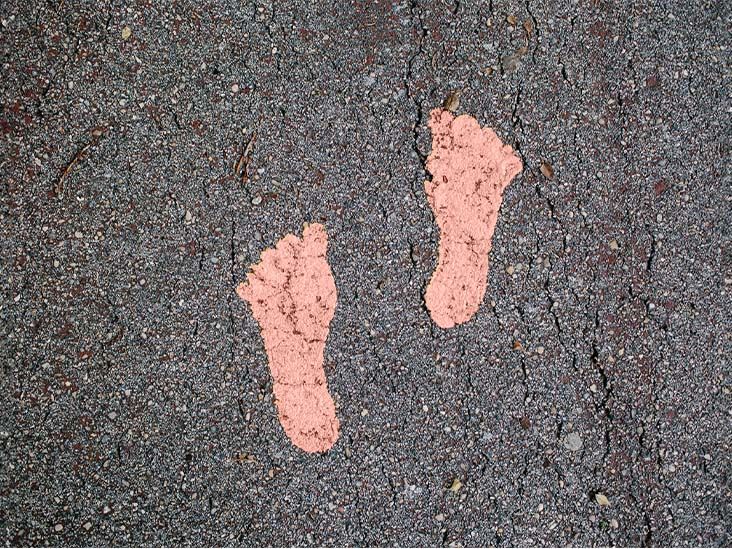 Two painted footprints on a path