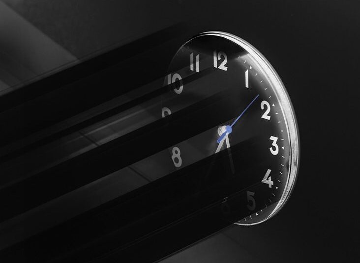 Shadows are cast on a wall clock