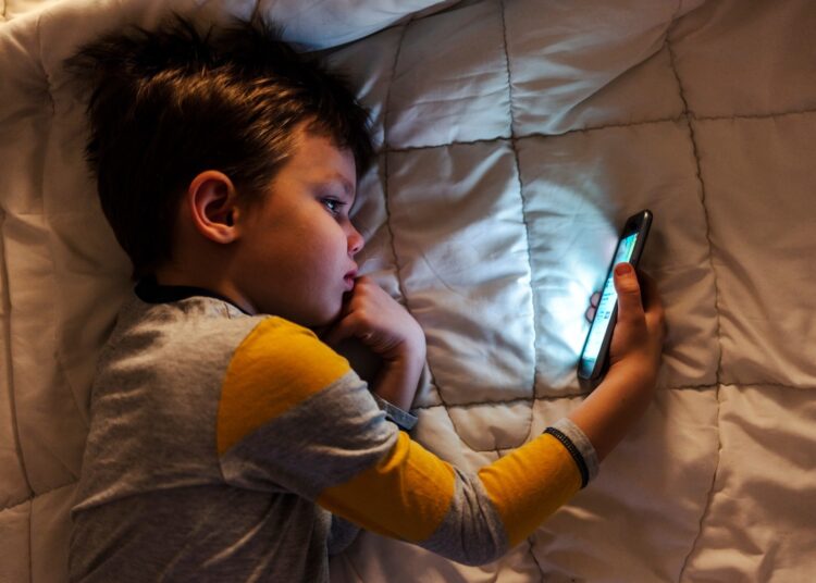 Cute little boy using a smartphone.