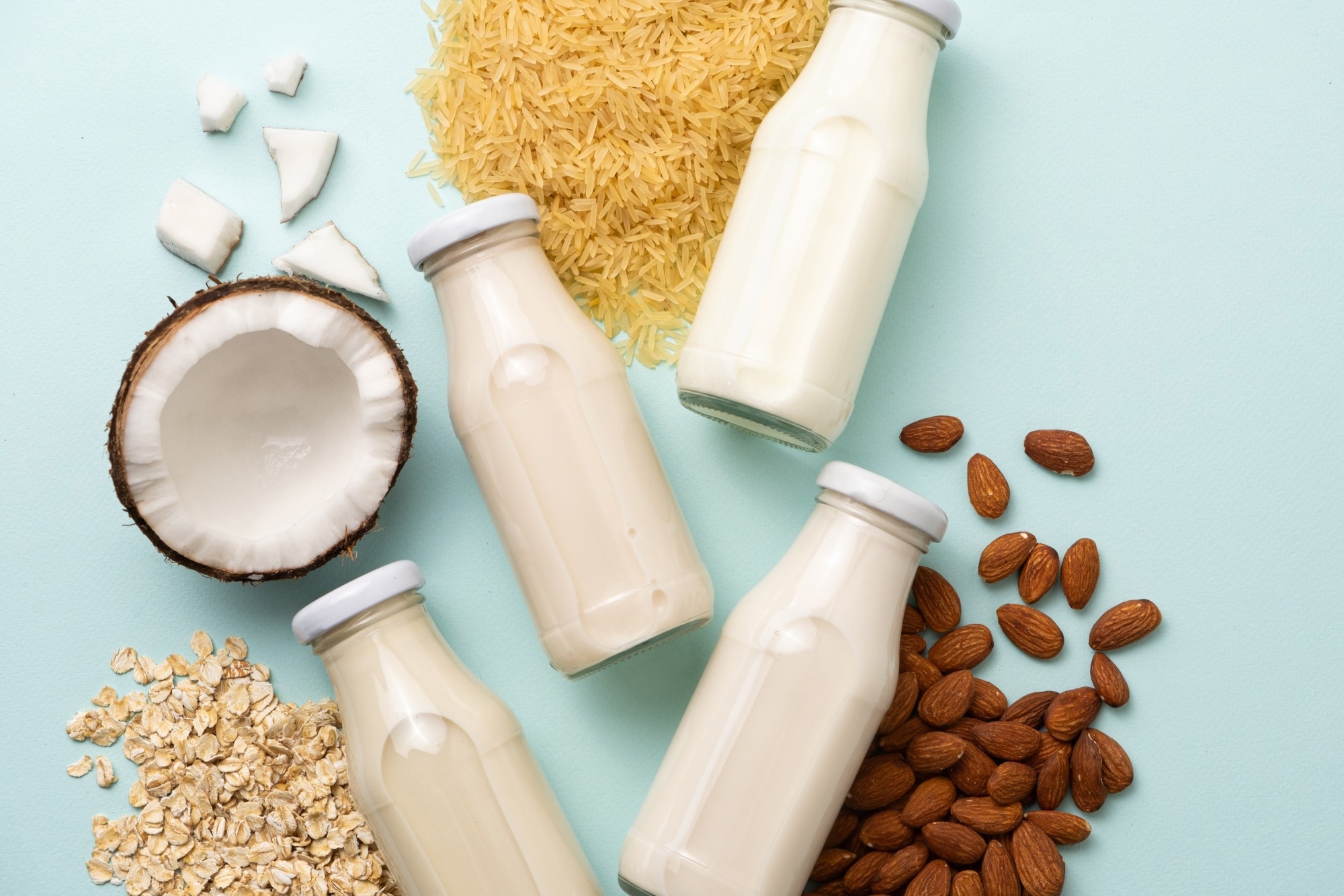 Types of plant-based milk in glass bottles