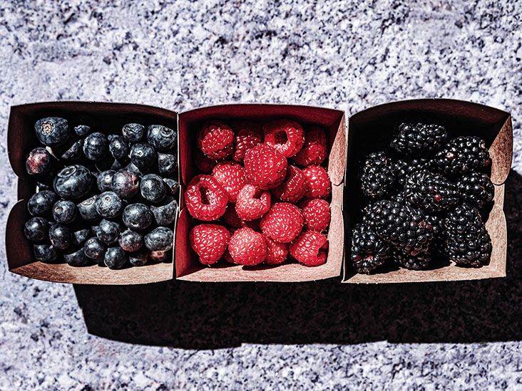 Blueberries, strawberries, and blackberries in three carton containers side by side