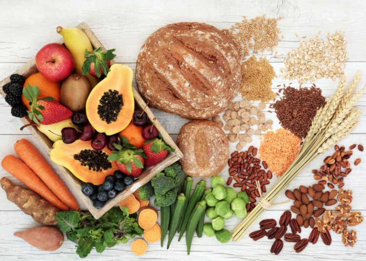 Healthy high fibre diet food concept with legumes, fruit, vegetables, wholegrain bread, cereals, grains, nuts and seeds