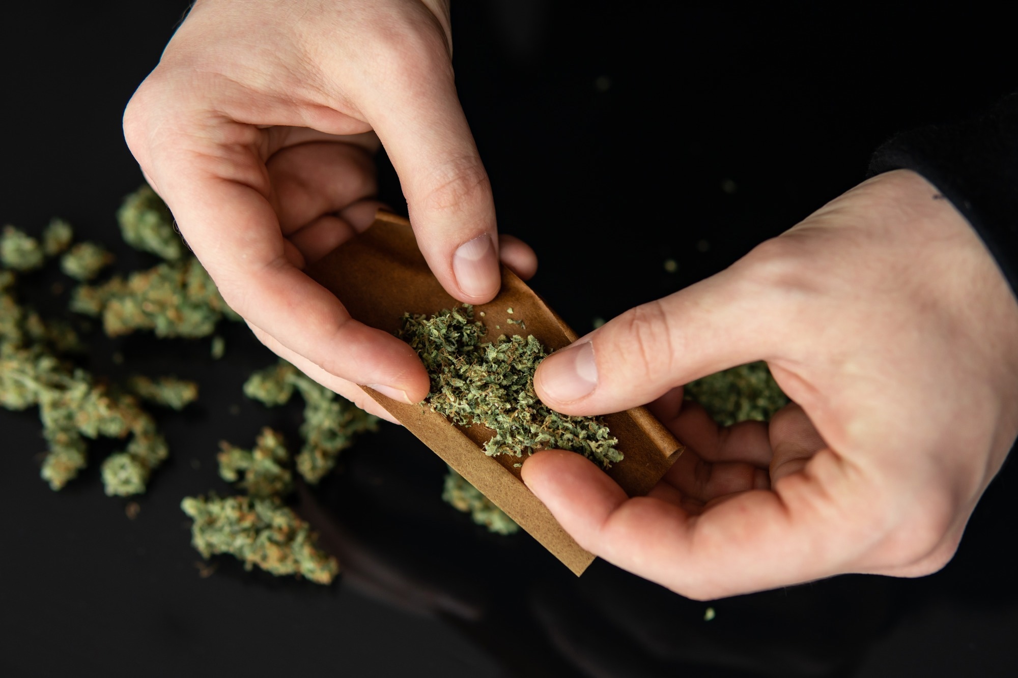 Man rolling a marijuana joint