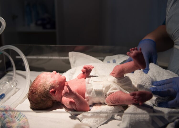 A young baby girl is born premature weighing just 4lbs, pictured here less than 5 minutes old