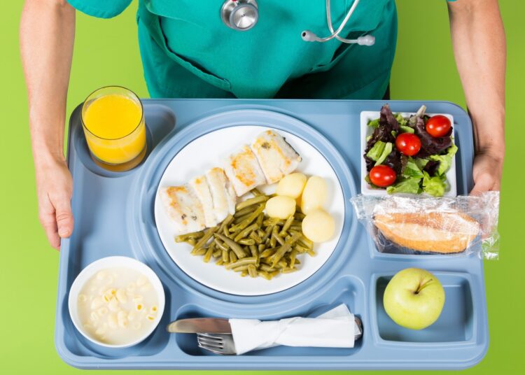 Health professional with a tray of food