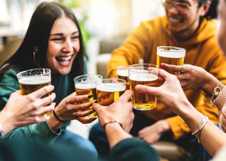 group of people cheering and drinking beer
