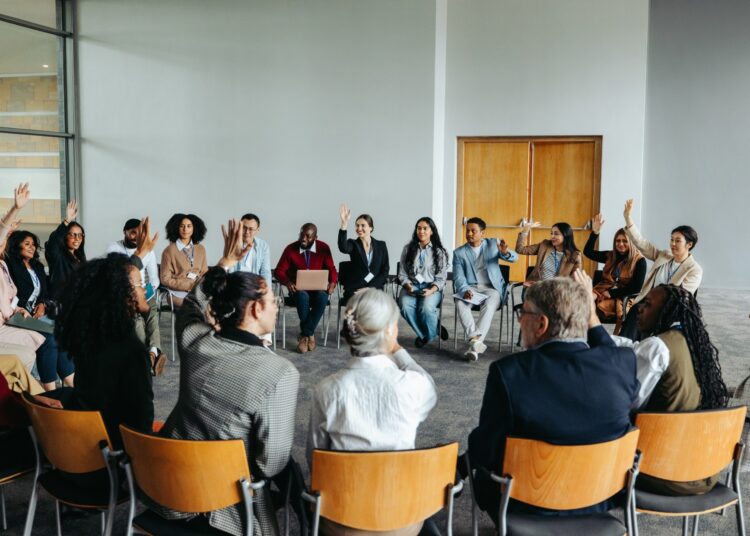 Group of diverse people participating in a support group meeting.