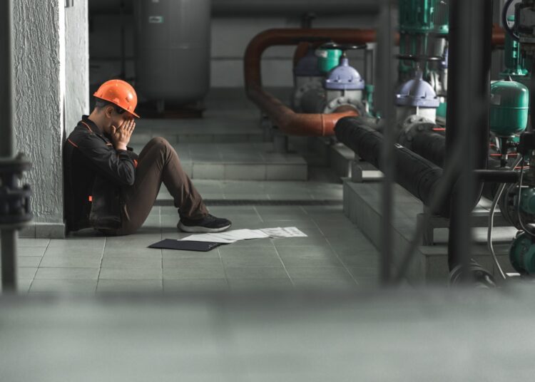 tired energy engineer sitting on the floor