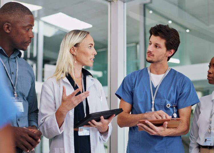 Healthcare staff and leader talking clinic results