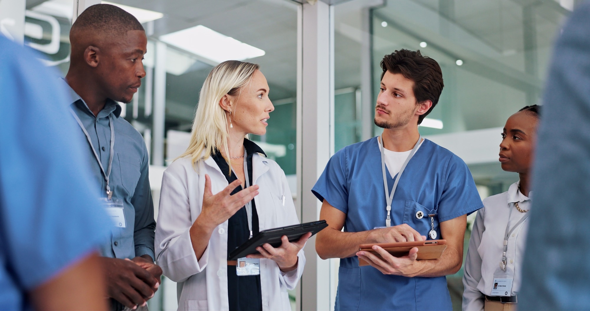 Healthcare staff and leader talking clinic results