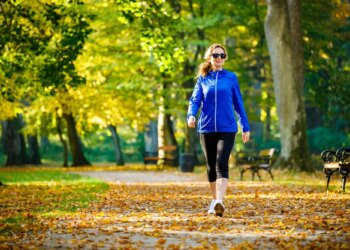 Middle-aged woman walking in city park